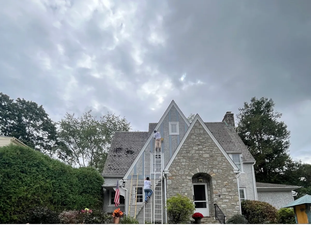 Historic multi-story home exterior surrounded by mature trees
