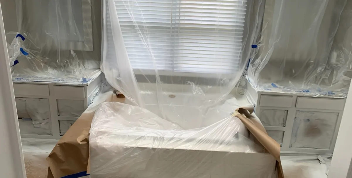 Protected room with patched walls and masking before painting