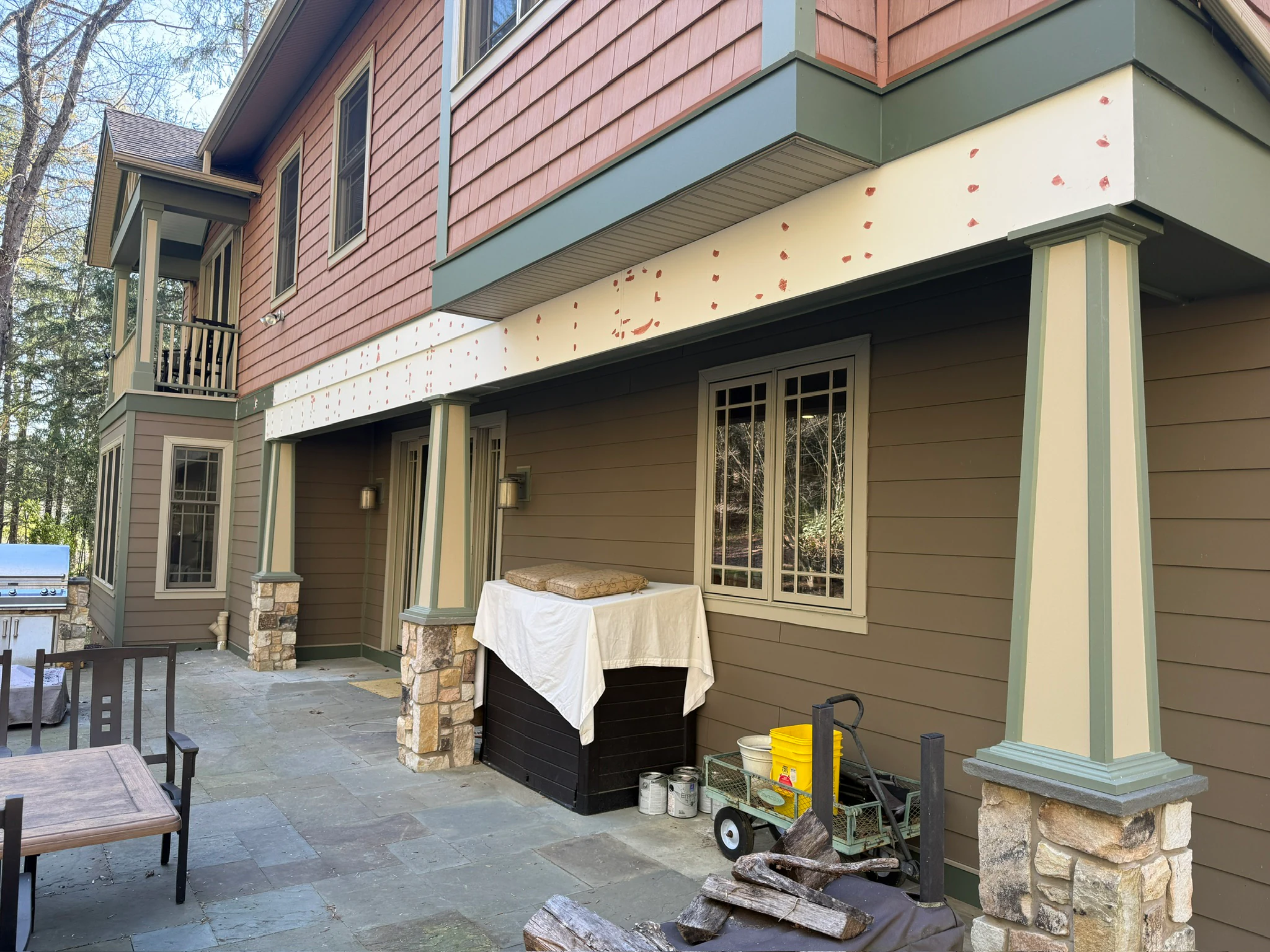 Exterior restoration work around a covered patio and support columns