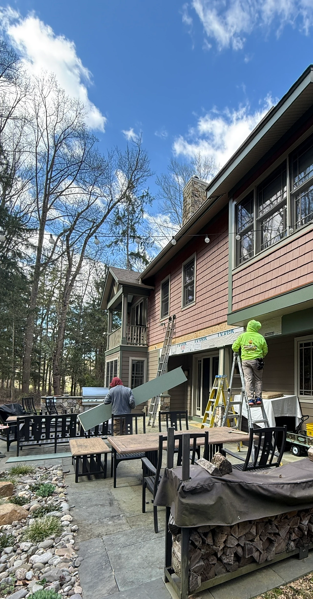 Exterior renovation crew working along a residential patio