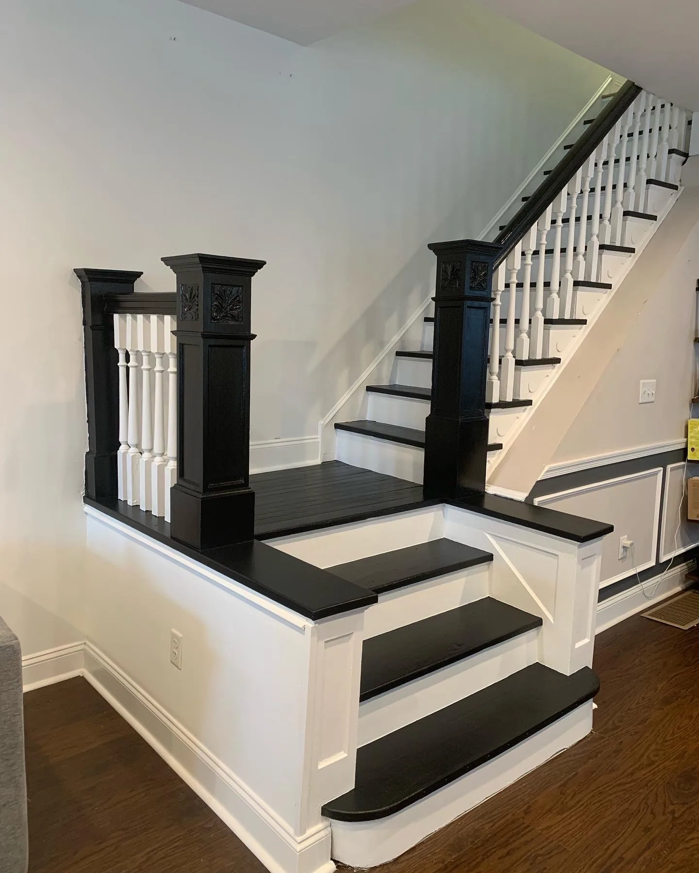 Finished black-and-white staircase with restored trim