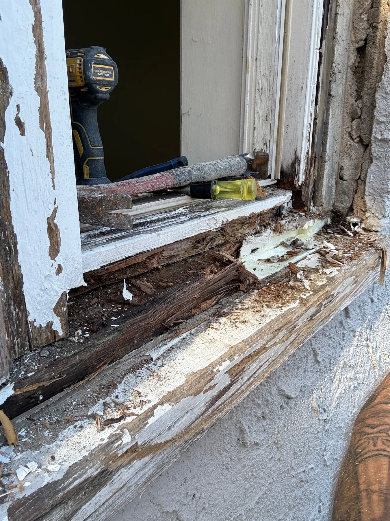 Deteriorated exterior window trim before restoration