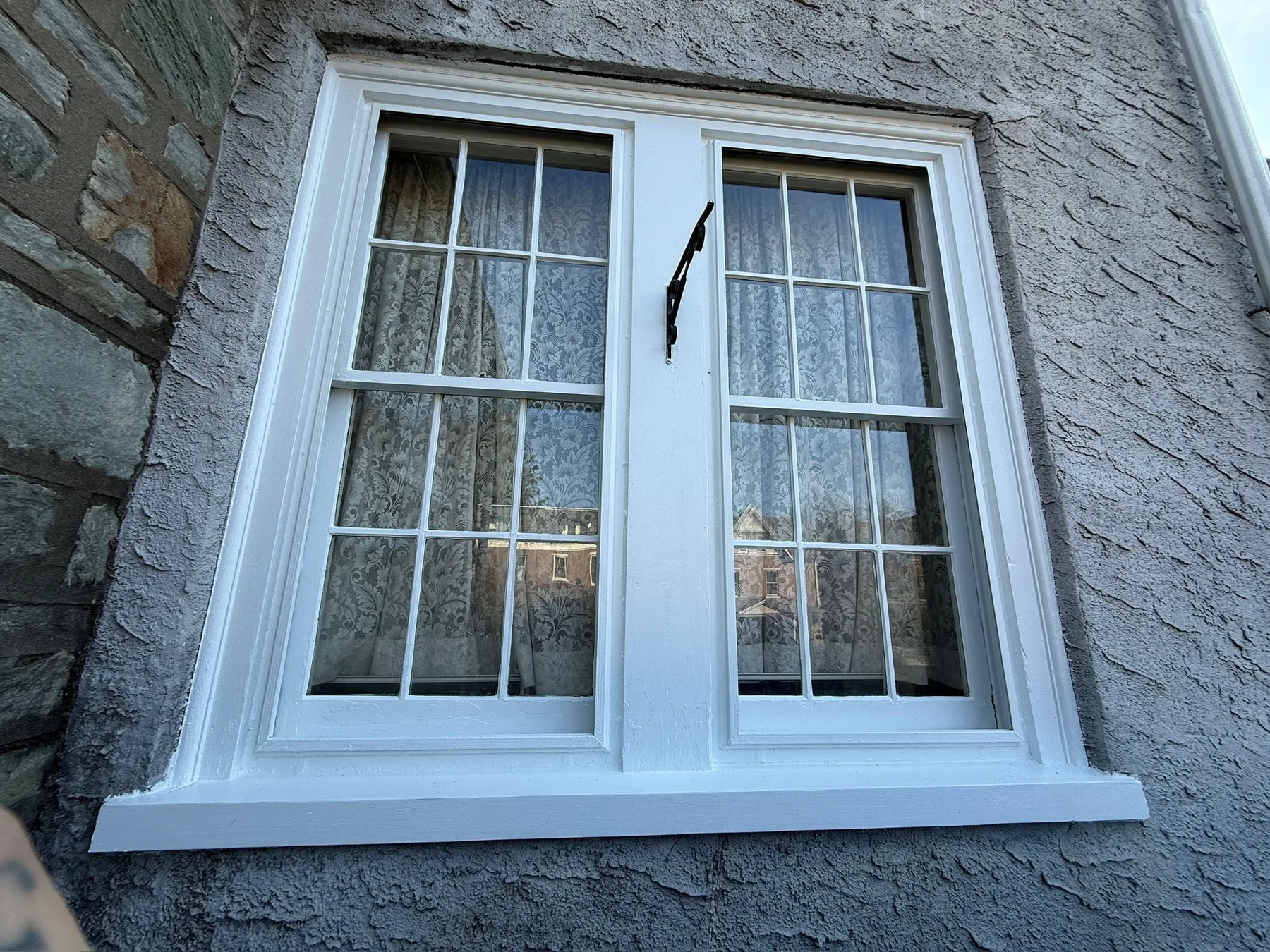 Restored historic exterior windows with crisp white trim