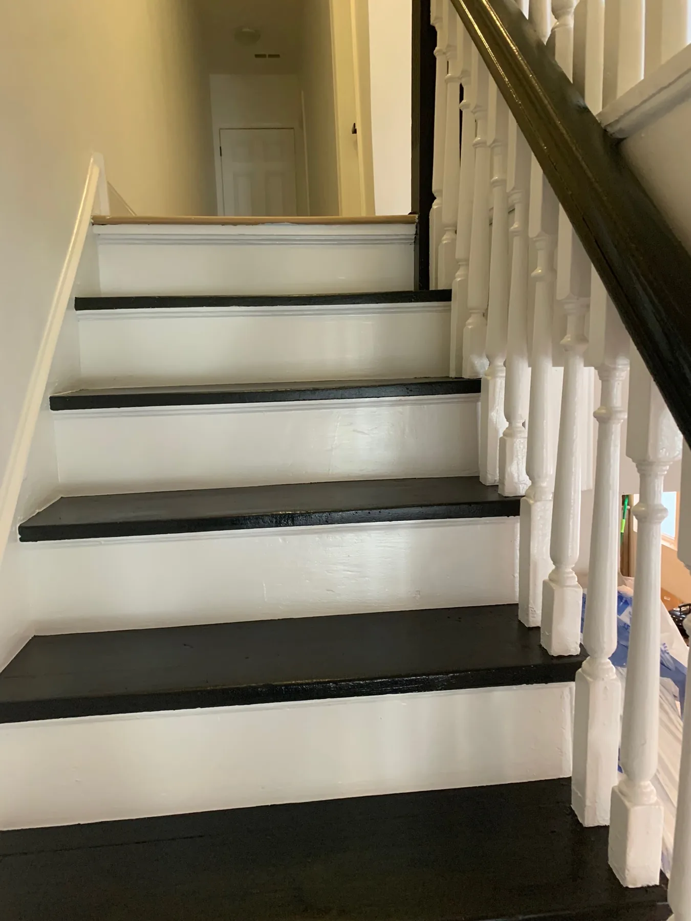 Finished black-and-white staircase treads and spindles