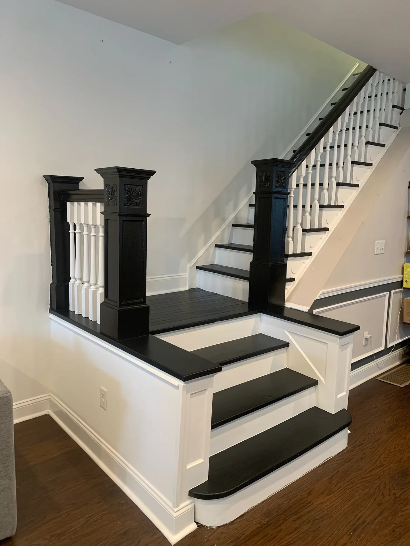 Restored staircase with black posts and white trim