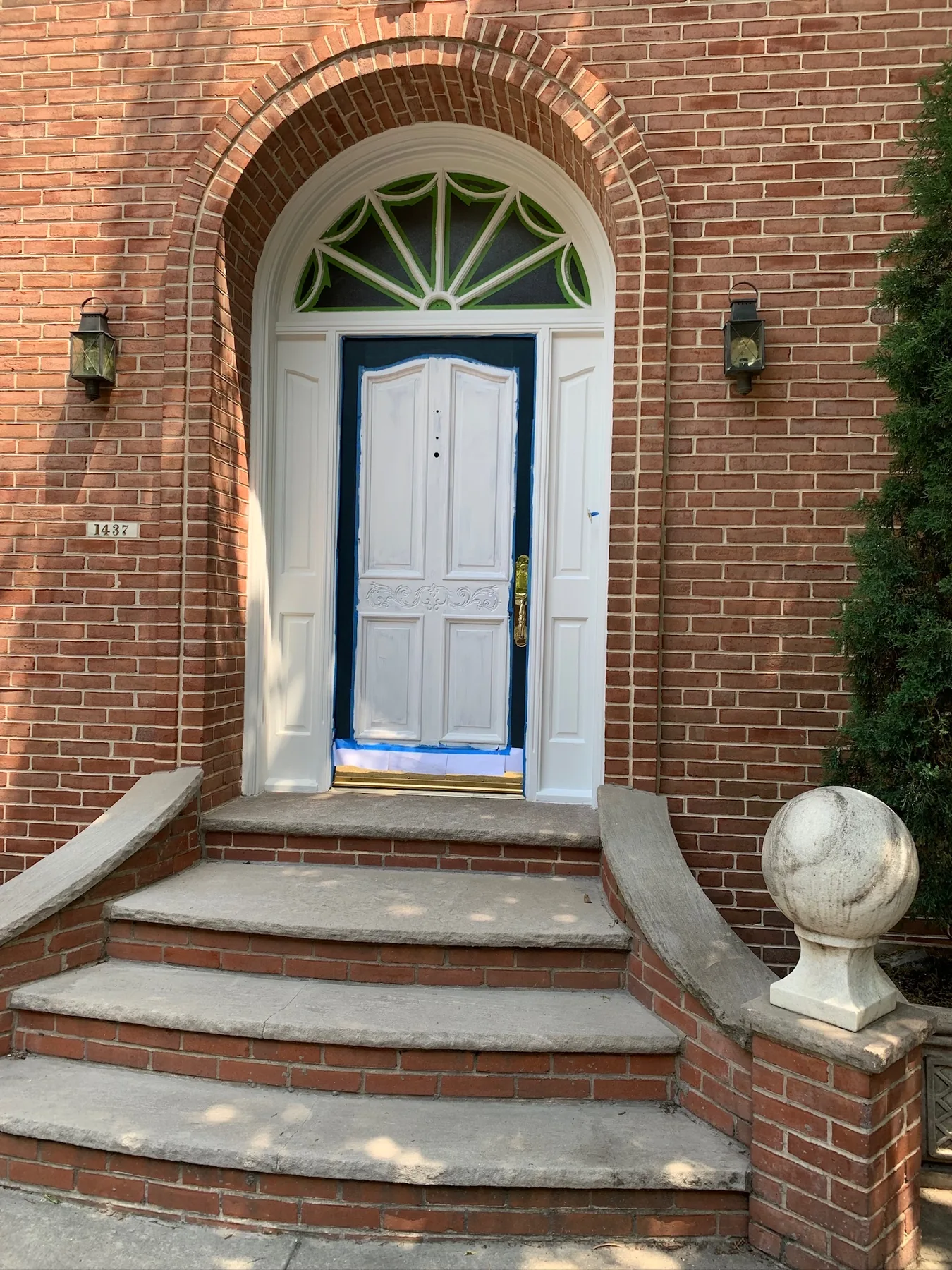 Primed front door and surrounding historic trim