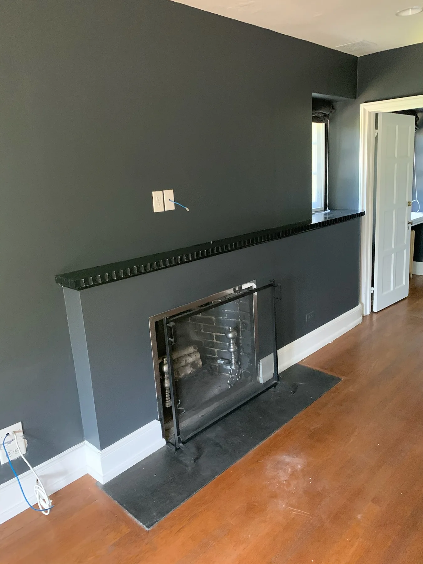 Dark accent wall and fireplace after painting