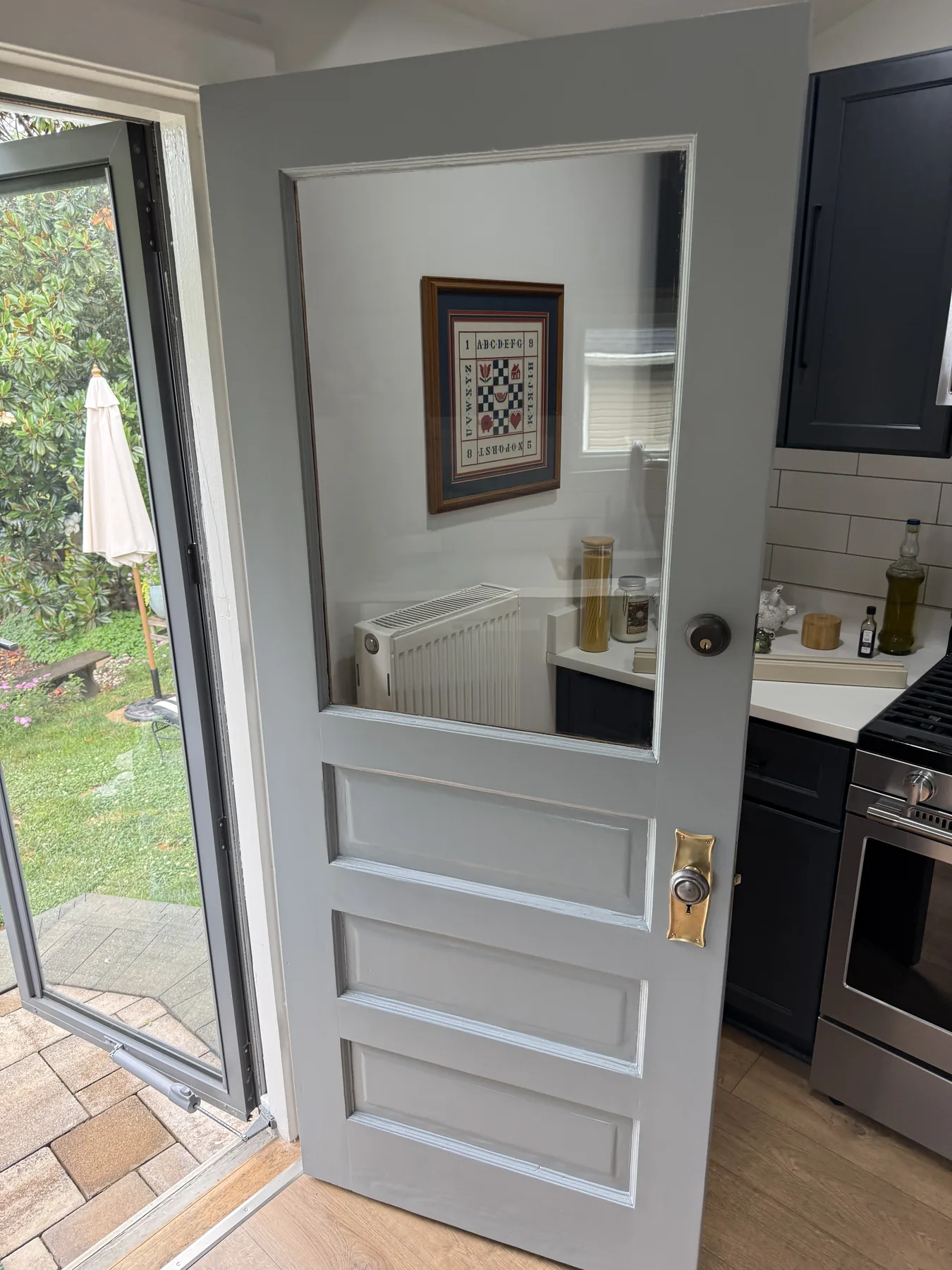 Restored gray glazed interior door in a finished kitchen