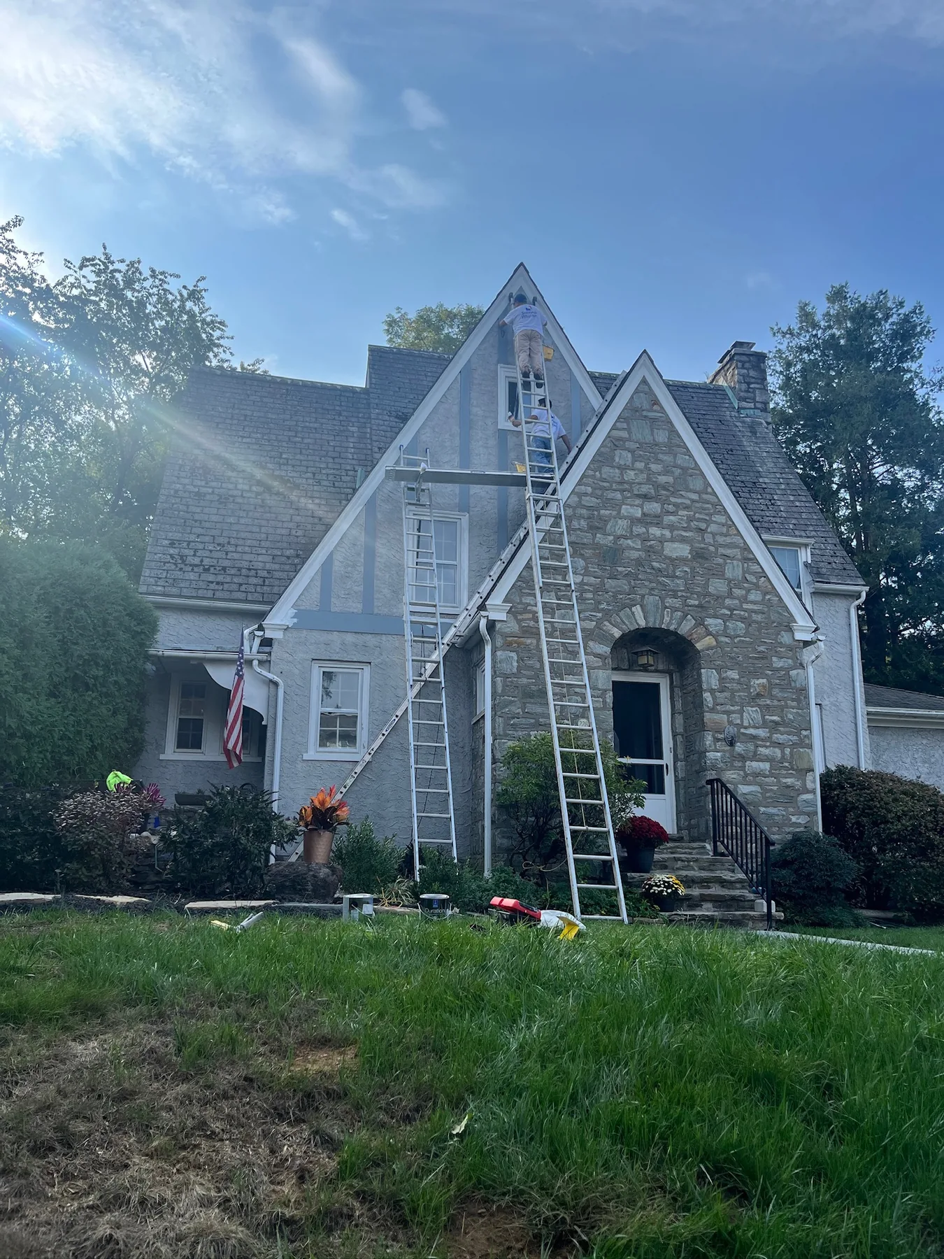 Exterior painting crew on a period stone home