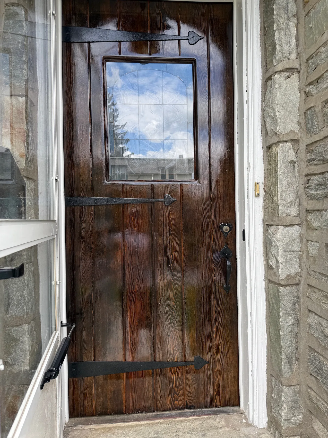 Restored stained wood door with renewed hardware